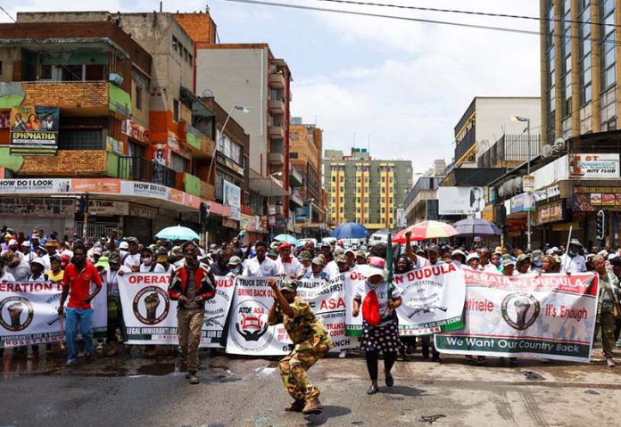 Anti-migrant vigilante group Dudula stokes tensions in South Africa Dudula